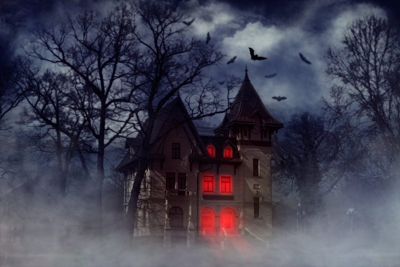 Halloween creepy house with bats and red light from the windows
