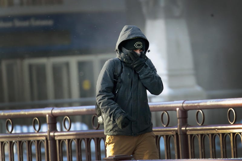 A commuter walks through downtown in bitter cold weather. 