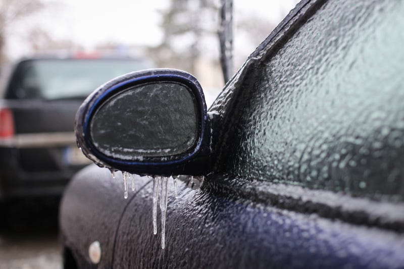 Freezing rain on a car window and mirror. 