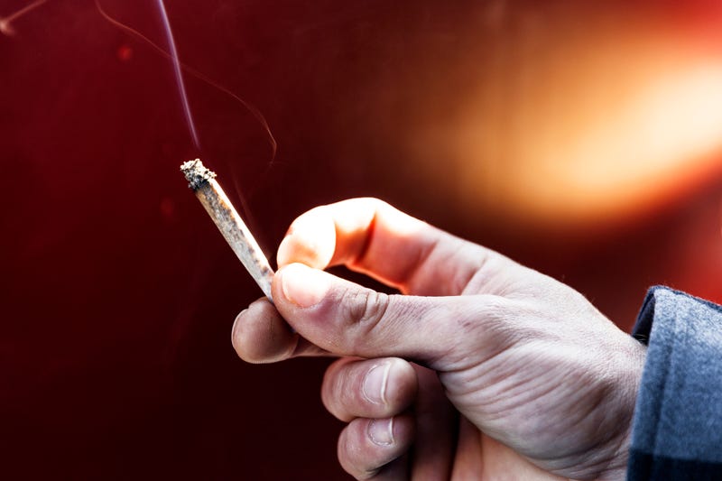 Young man smoking a joint. 