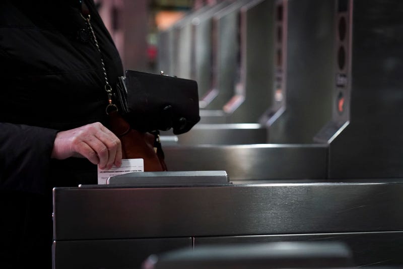 A customer swipes her metro card as she moves through the turnstiles at the Fulton Center subway station, February 27, 2019 in New York City.