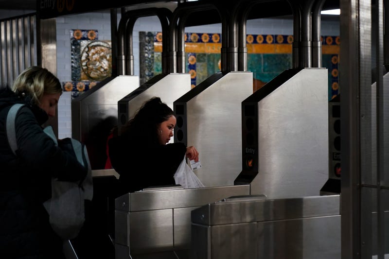A customer swipes her metro card.