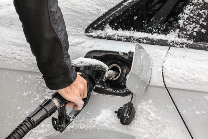 Pumping gas into snow-dusted car