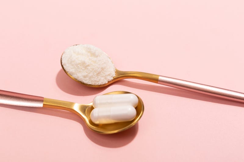 Supplements and powder on a pink background stock photo. 