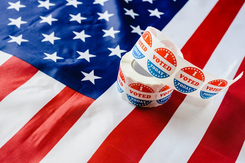 Voting stickers and American flag