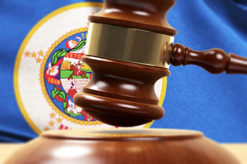 Gavel in front of a Minnesota flag.