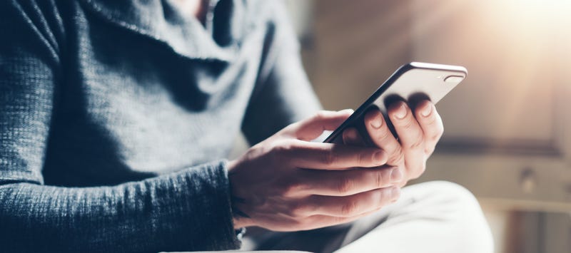 Person dialing number on phone