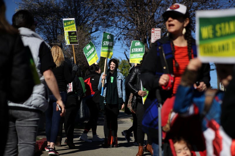 Oakland Unified School District students, teachers and parents carry signs as they picket outside of Manzanita Community School on February 21, 2019 in Oakland, California.