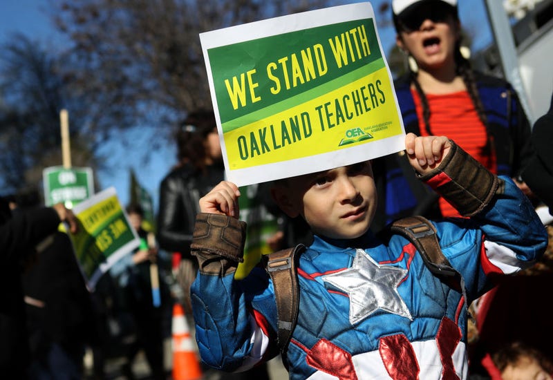 Oakland Unified School District students, teachers and parents carry signs as they picket outside of Manzanita Community School on February 21, 2019 in Oakland, California.