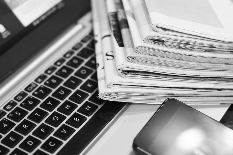 News. Newspapers, Laptop and Smartphone - Sources of Information. Finance Magazines and Journals Stacked in Pile on Keyboard of Computer. Business Concept