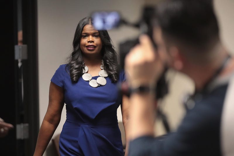 Kim Foxx walks past camera