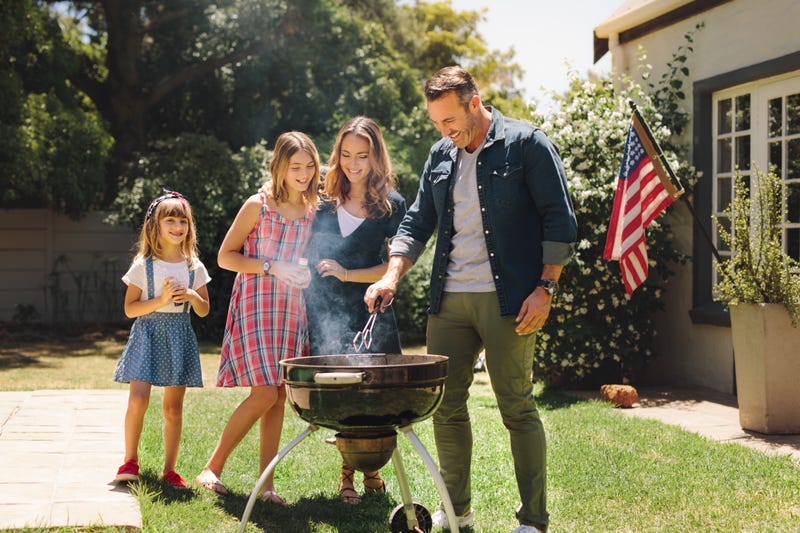 Family grilling outside - File Photo