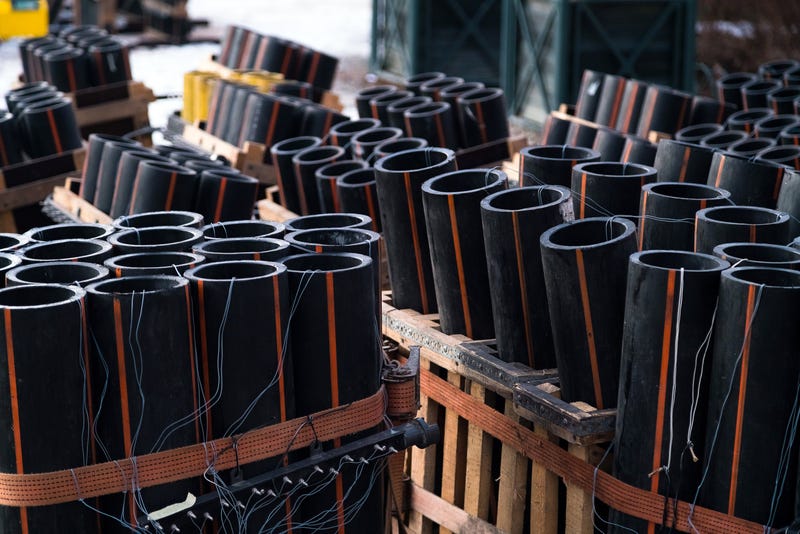 Preparation of big firework show with tubes filled with gunpowder and electric wire on ground. Fireworks festival, entertainment, danger. 4th of July