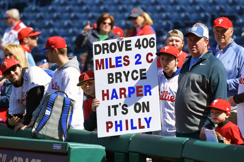 Fans wait for Bryce Harper of the Philadelphia Phillies before a game against the Atlanta Braves.