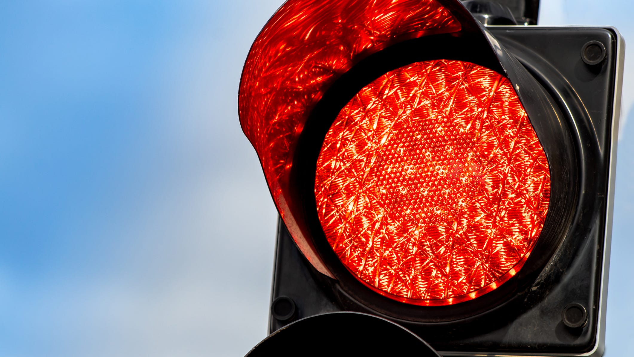 Man shot at a red light in Dallas is in stable condition, the gunman is still on the loose