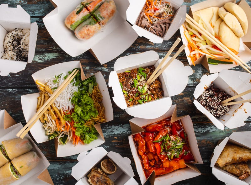 FILE - Assorted Chinese dishes in paper delivery boxes: sweet and sour chicken, dim sum, spring rolls, noodles, salad, rice, steamed buns, dips. 