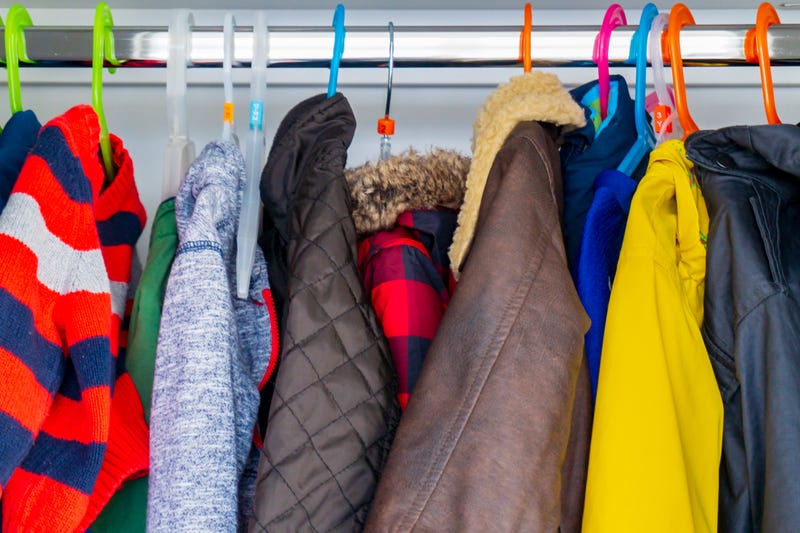 winter coats hanging on clothing rack