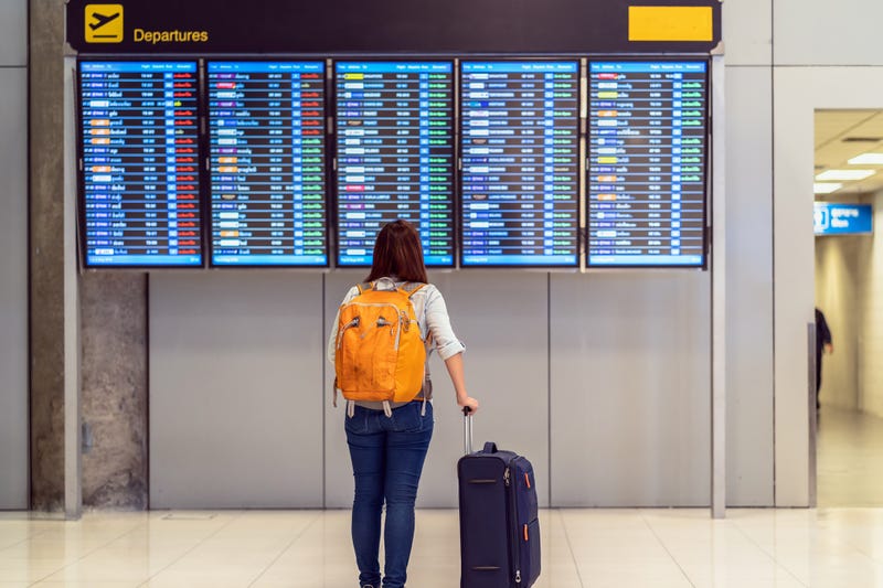 Traveler looking at a flight board.