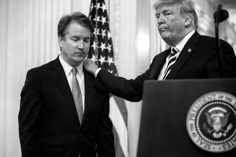 U.S. President Donald Trump (R) puts his hand on Supreme Court Associate Justice Brett Kavanaugh's shoulder during his ceremonial swearing in in the East Room of the White House October 08, 2018 in Washington, DC. Kavanaugh was confirmed in the Senate 50-48 after a contentious process that included several women accusing Kavanaugh of sexual assault. Kavanaugh has denied the allegations. (Photo by Chip Somodevilla/Getty Images)