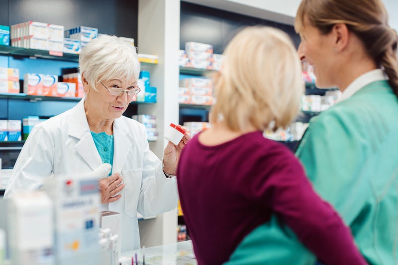 Parent and child at a pharmacy counter.