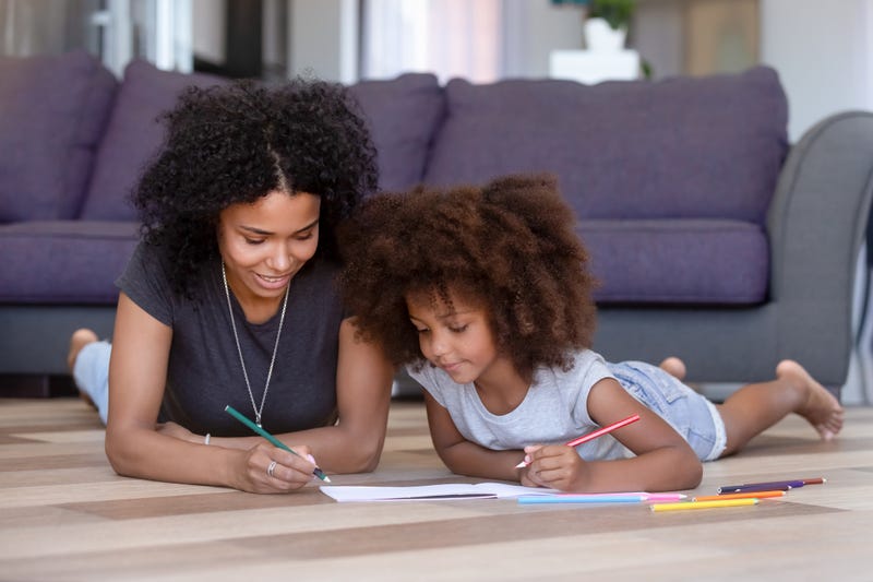 mother and daughter draw together