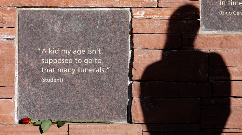 Kailey Slusher's shadow is cast on the Columbine Memorial on April 19, 2019 in Littleton, Colorado. April 20 will mark 20 years since the shooting that claimed 13 lives at Columbine High School in Littleton, Colorado. (Photo by Joe Mahoney/Getty Images)