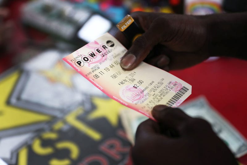 George Hollins buys a Powerball ticket at the Shell Gateway store on March 26, 2019 in Boynton Beach, Florida.