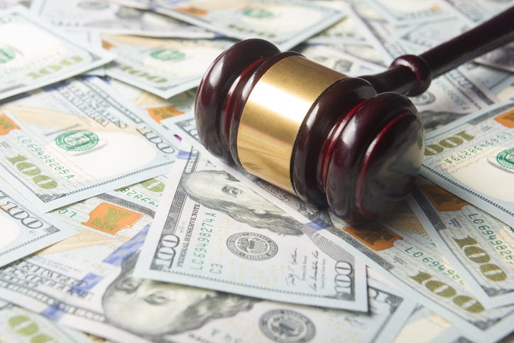 Gavel on top of $100 bills