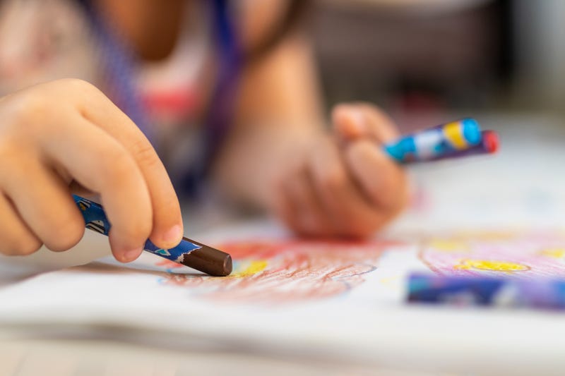 Kid coloring with crayon
