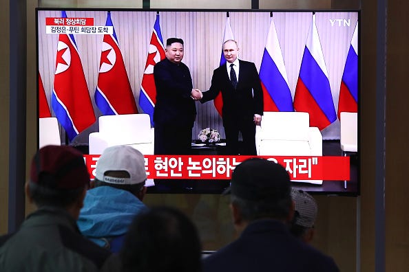 South Koreans watch a television broadcast reporting the North Korean Leader Kim Jong Un meeting with Russian President Vladimir Putin, at the Seoul railway station on April 25, 2019 in Seoul, South Korea.