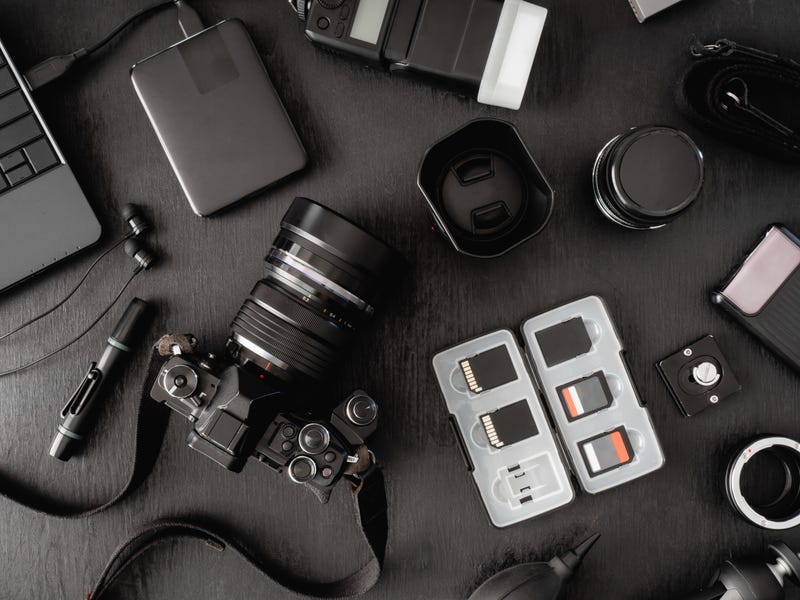 Cameras and equipment lie on a table