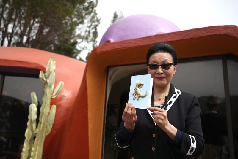 Florence Fang, owner of the so-called Flintstone's House, holds a card that was sent to her by a supporter.