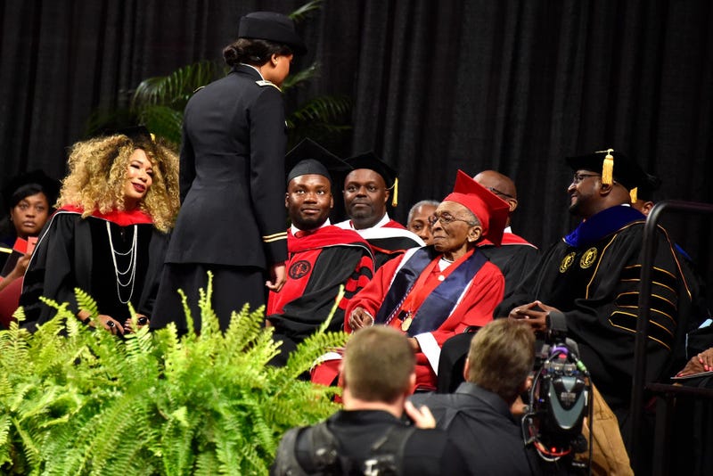 Elizabeth Bernice Barker-Johnson (2nd from right), 99, World War II Veteran, 6888th Central Postal Directory Battalion, receives her degree