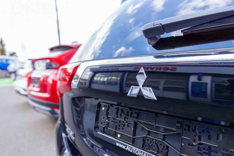 Mitsubishi logo on a Mitsubishi car at a car dealer.