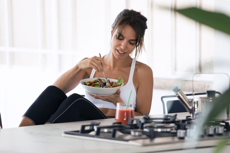 woman eating breakfast in workout gear. 