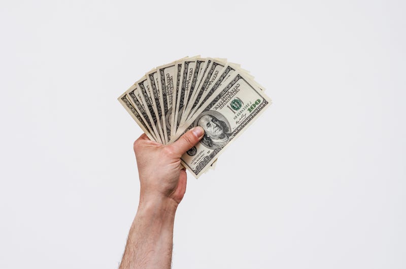 Man's hand holds U.S. money
