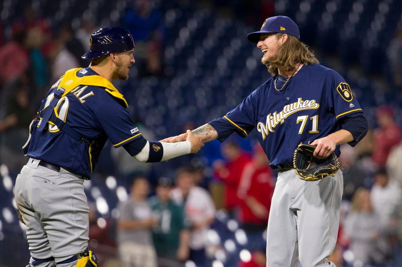 Josh Hader greets teammate Yasmani Grandal at home plate
