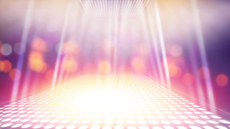 Abstract illuminated light stage with colorful bokeh background