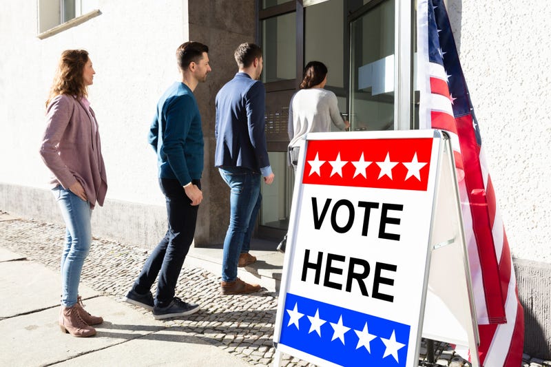 Voters stand in line waiting to get into polling place