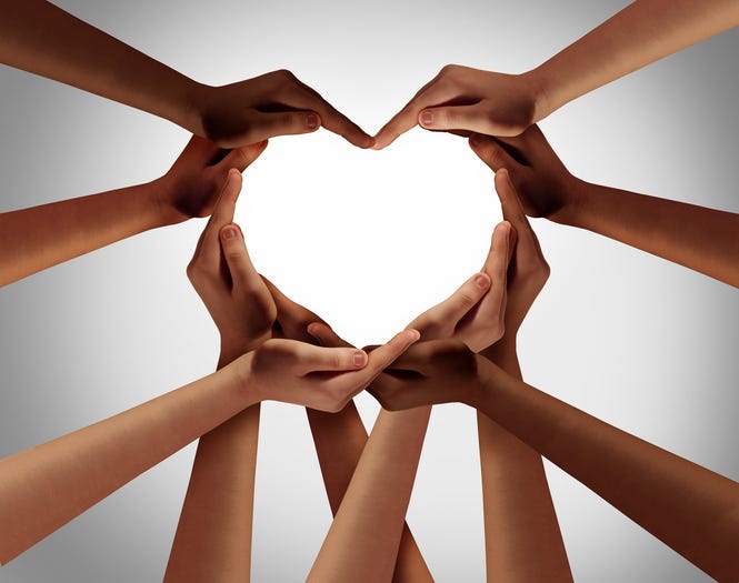 Heart hands as a group of diverse people hands connected together shaped as a love symbol expressing the feeling of being happy and togetherness
