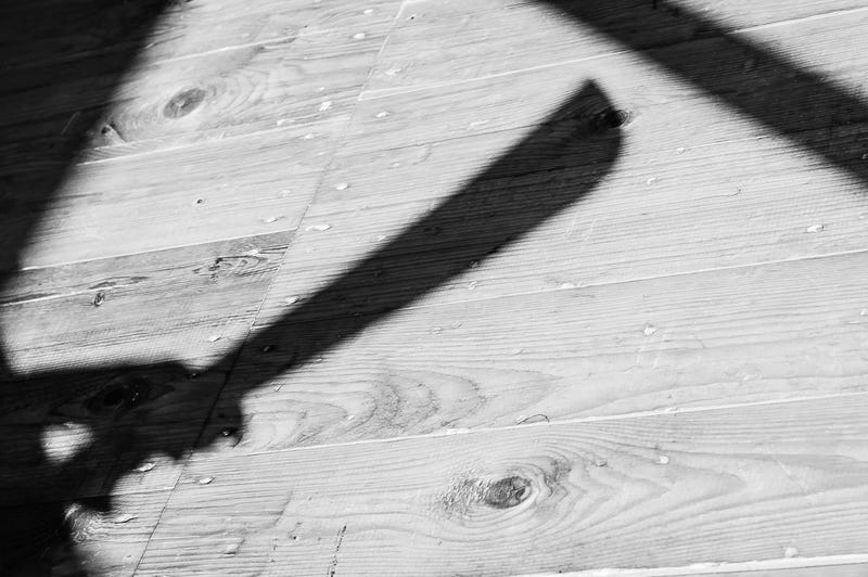 FILE: A shadow of a hand holding a machete.