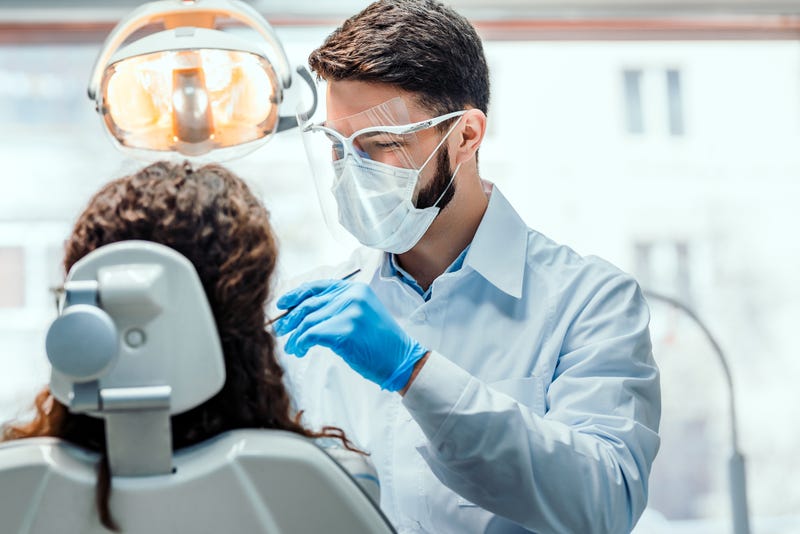 Dentist working with patient