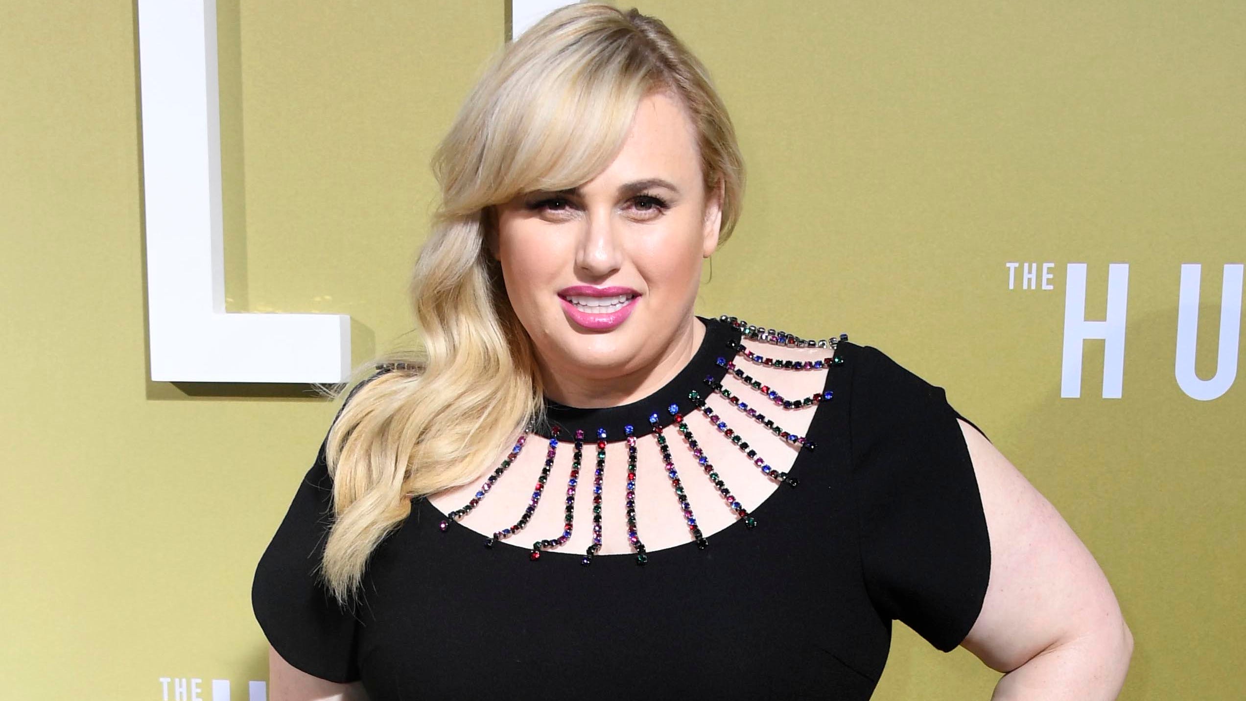 Rebel Wilson shows off slim figure in a fitted black T-shirt during European holiday