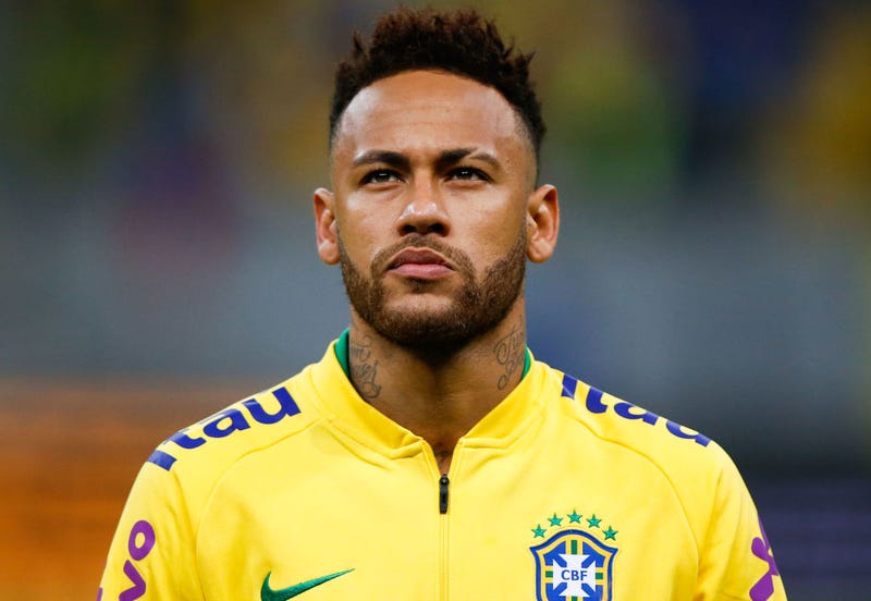 Neymar Jr. of Brazil looks on during the national anthem before the friendly match against Qatar at Mane Garrincha Stadium on June 05, 2019 in Brasilia, Brazil.