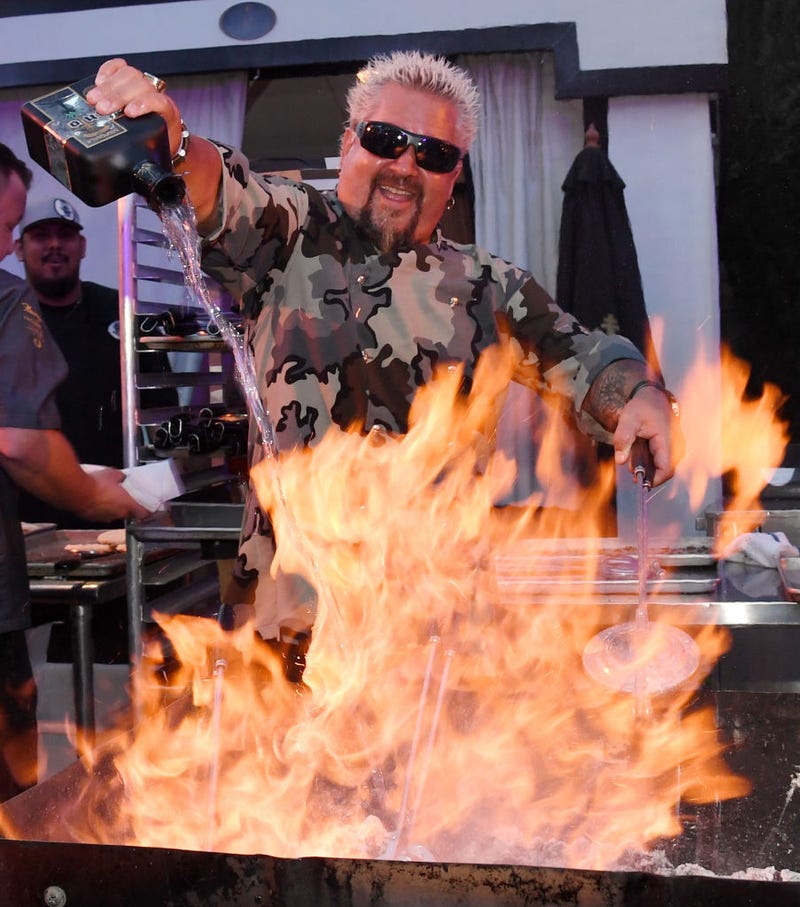Guy Fieri prepares food using Santo Puro Mezquila at the Guy Fieri's Vegas Kitchen & Bar booth at the 13th annual Vegas Uncork'd by Bon Appetit Grand Tasting event in Las Vegas, Nevada in 2019.