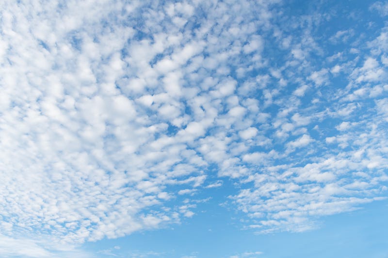 Photo of the sky with light cloud cover. On the summer solstice, St. Louis is experiencing its first orange-level air quality day.