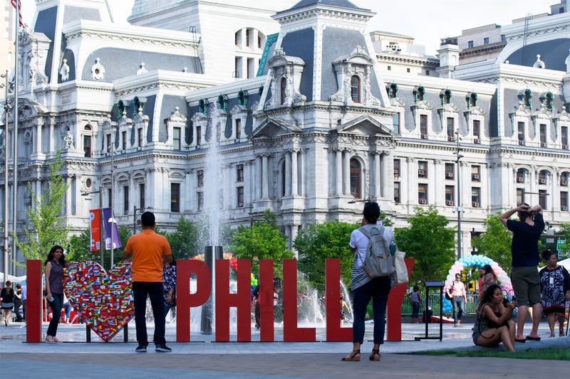 Tourists and locals take pictures at a large "I Love Philly" sign at LOVE Park in Center City Philadelphia in the summer of 2019.