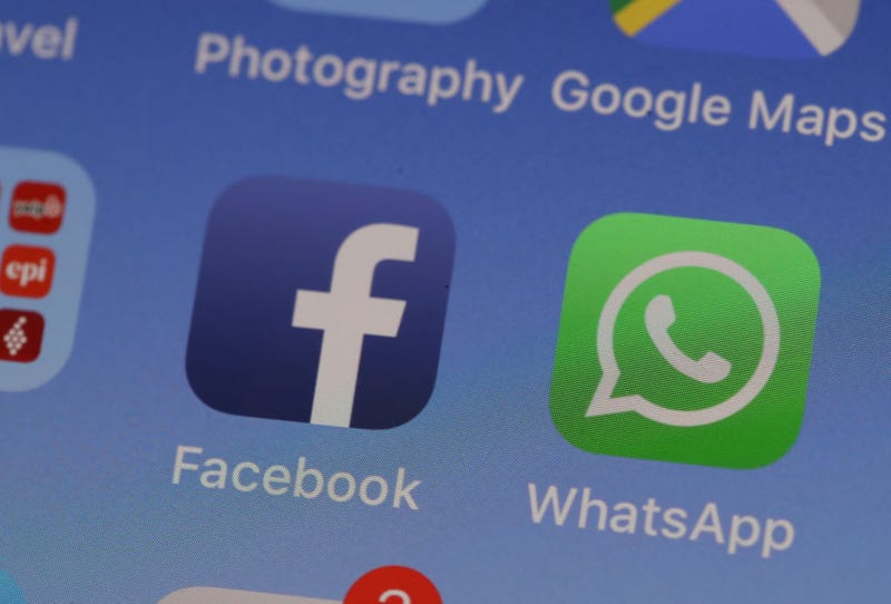 The Facebook and WhatsApp logos displayed on an iPhone.
