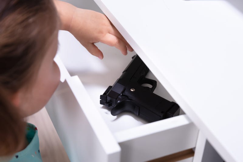 An unlocked gun awaits the hands of a curious child.