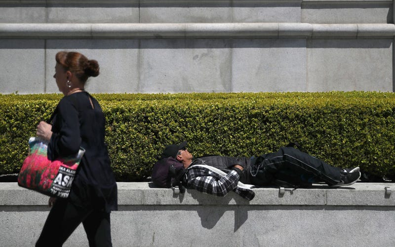 A homeless man sleeps outside of the Asian Art Museum on May 17, 2019 in San Francisco, California.
